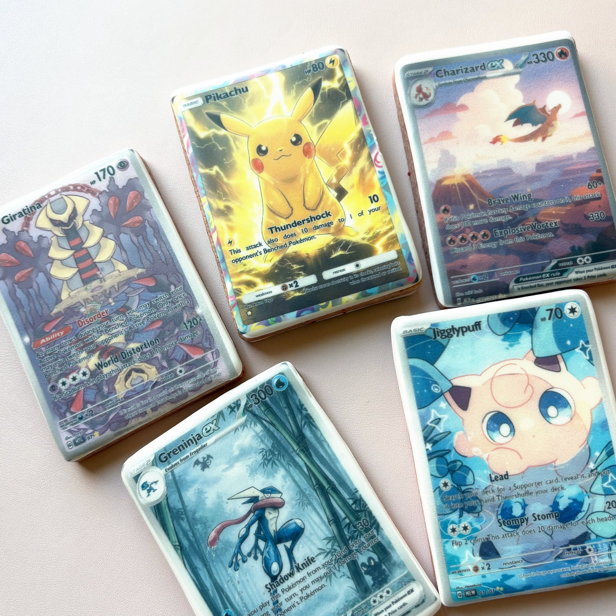 Pokemon card cookies: five trading-card designs printed on royal icing, including Pikachu, Charizard and Jigglypuff